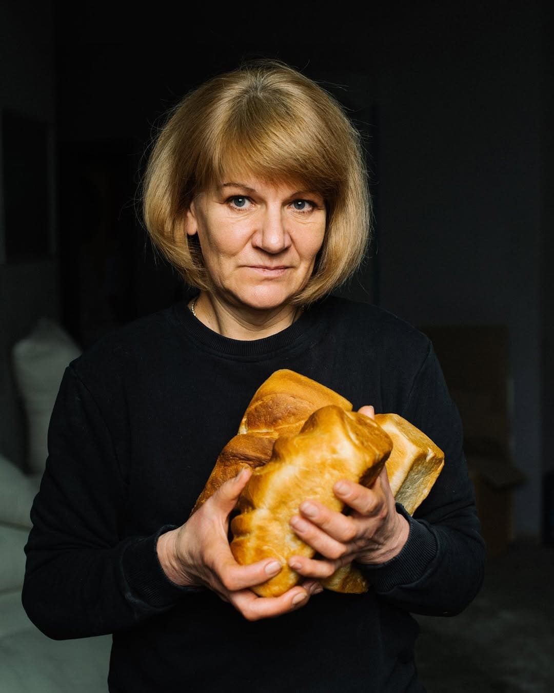жінка тримає хліб у руках